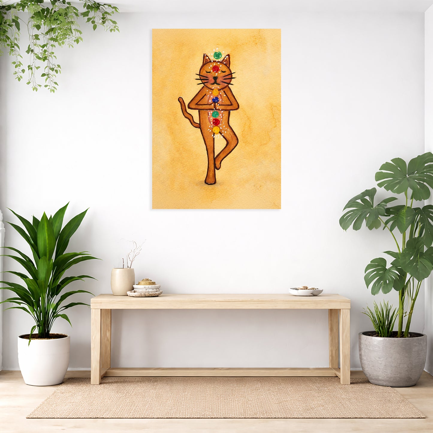 Decorative wall art of a cat with chakra symbols on an orange background, displayed in a room with plants and a wooden bench.