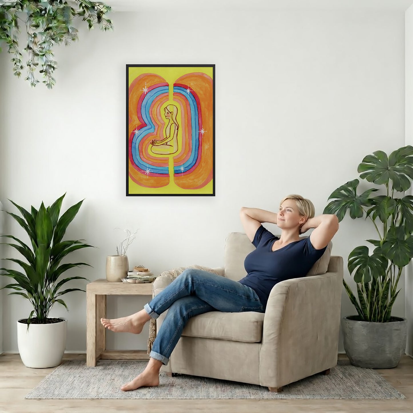 Rainbow aura energy field portrait on mindfulness framed poster. The poster is framed and is in the center of the living room wall. To the right a woman is relaxing in a chair with her hands behind her head. To the left is a green floor plant and a hanging green plant. To the right of her is a green floor plant.