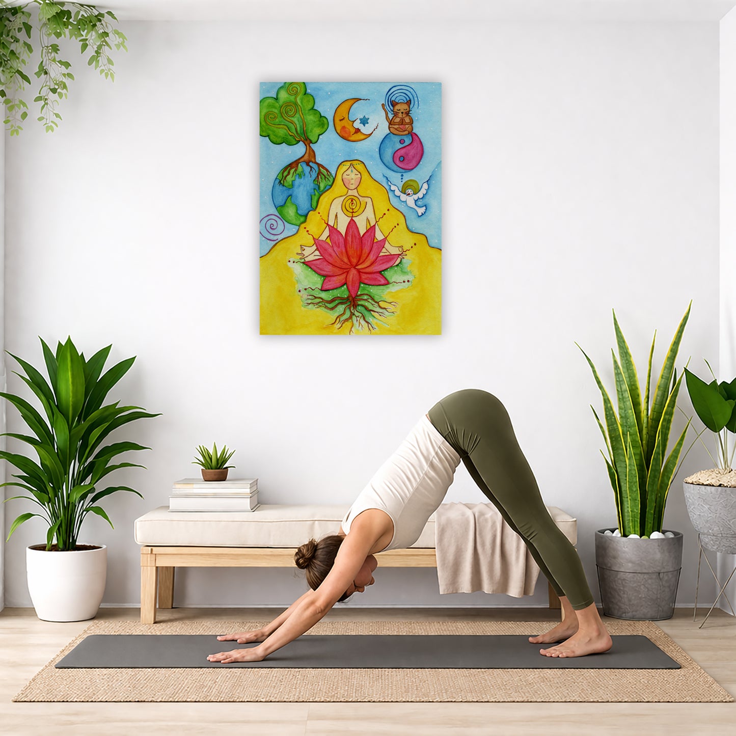 A woman with a glowing heart chakra is meditating on top of a red lotus flower. This is a canvas print of the original hand-painted watercolor by Brazilian artist Thaís Suizo for the LET'S MEDITATE SERIES of mediation guides. The poster is in the center of the living room wall. Below the poster a woman is doing the yoga posture downward facing dog on a yoga mat.