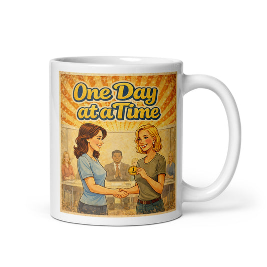 Mug with 'One Day at a Time' graphic design featuring two women shaking hands.
