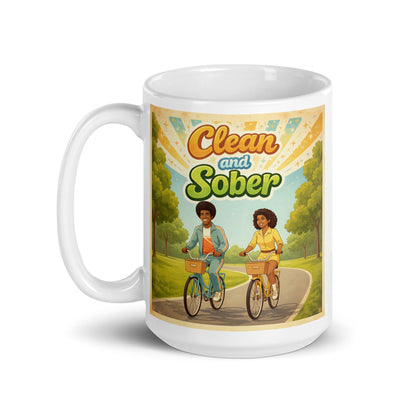 Sobriety Mug with illustration of two people riding bicycles and text 'Clean and Sober' on a scenic background.