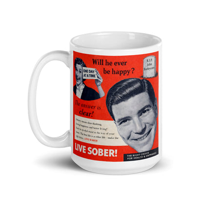 Mug with vintage-style advertisement featuring a smiling man and text about sobriety on a white background. Caption: The answer is clear. Live Sober!