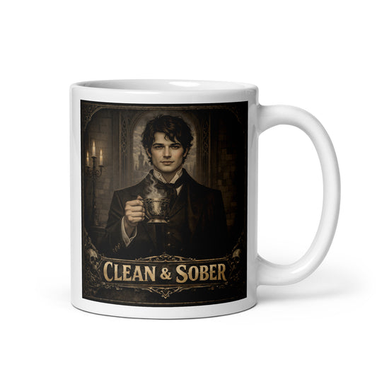 Dark academia gothic style coffee mug featuring a brooding young Victorian man in a black coat holding a steaming ornate brass cup by candlelight in a stone gothic hall with "Clean & Sober" in aged gold lettering and skull corner details