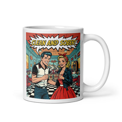 Cool swinging 1950s rockabilly style “Clean and Sober” illustration featuring a retro couple holding coffee mugs inside a vintage diner with checkerboard floors and jukebox for a sobriety themed coffee mug design.