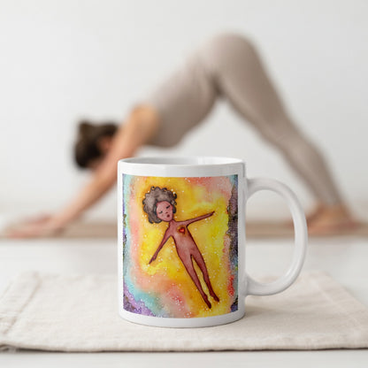 Floating astral body surrounded by glowing energy, spiritual meditation artwork representing consciousness, soul awareness and out-of-body experience, printed on a mindfulness coffee mug.  The mug is in front of a woman doing the yoga posture downward facing dog.