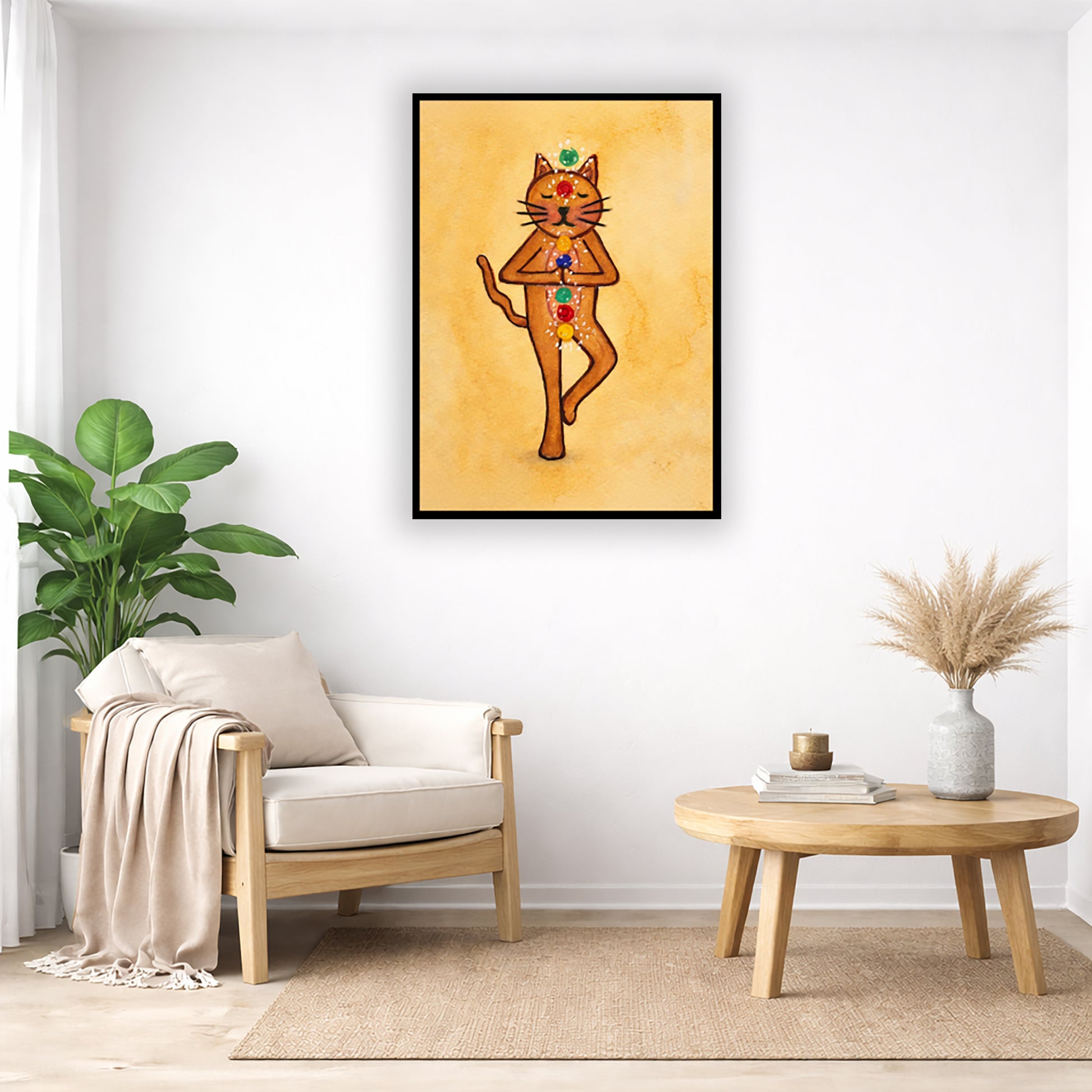 A brown cat standing in meditation with its chakras glowing framed poster.   This is a print of the original hand-painted watercolor by Brazilian artist Thaís Suizo. The poster is in the center of the living room wall. Below the poster to the left is a living room chair, a floor plant and white curtains. To the right is a small table with books, a candle and a vase with dry flora.
