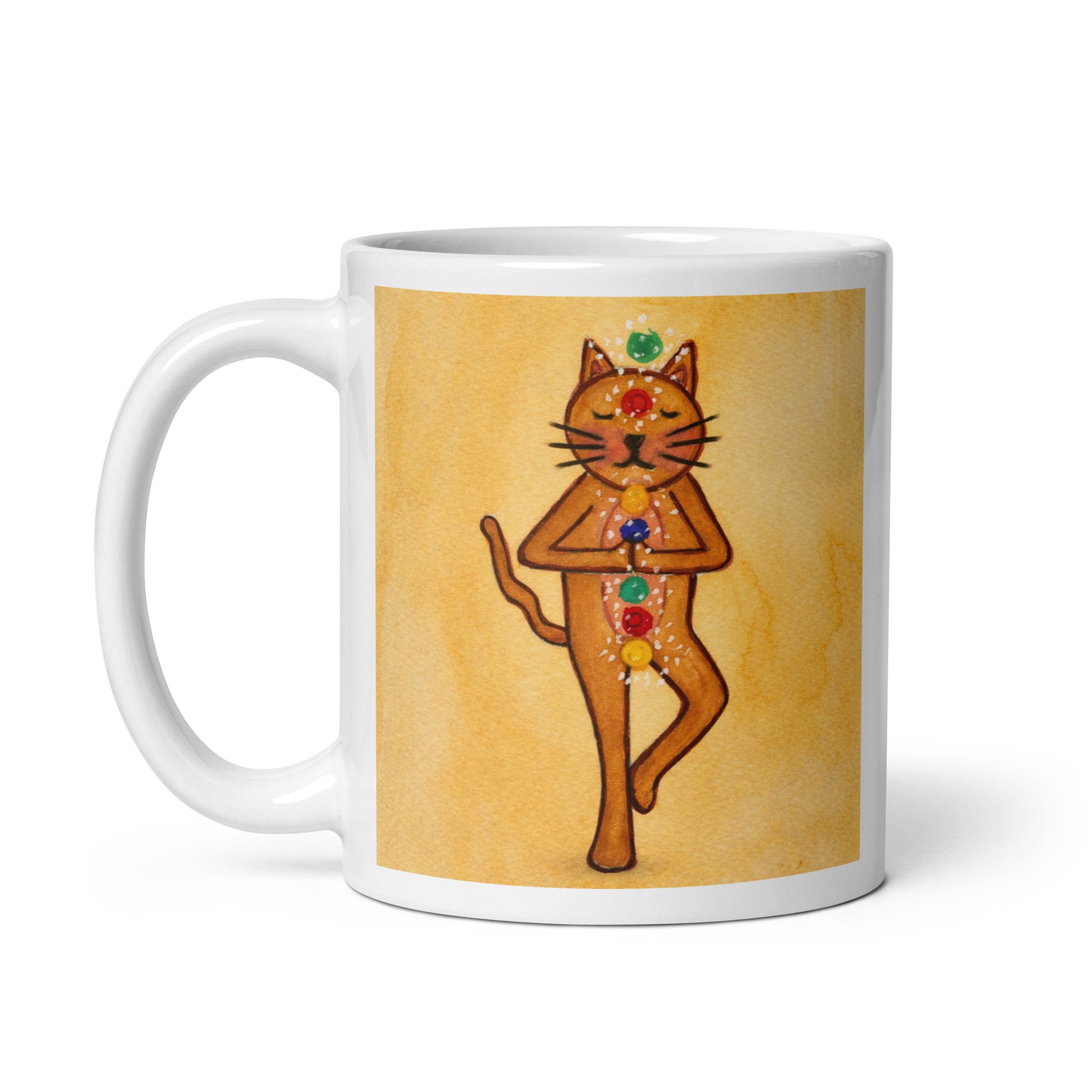 Brown cat standing in a meditation pose with glowing chakras along its body on a yellow background meditation mug. This illustration of a cat meditating is on both sides of the mug. In this image the handle of the mug is on the left side.