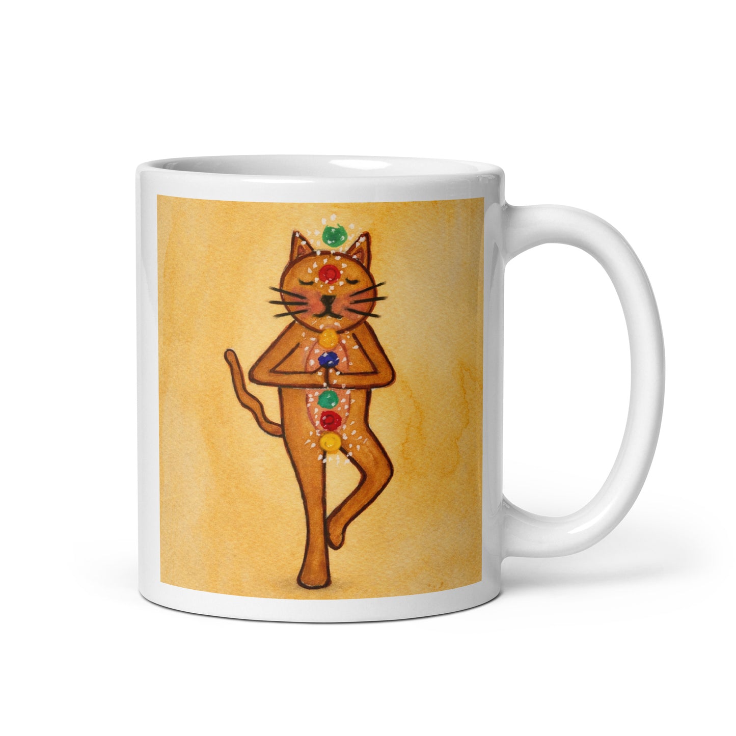 Brown cat standing in a meditation pose with glowing chakras along its body on a yellow background meditation mug. This illustration of a cat meditating is on both sides of the mug. In this image the handle of the mug is on the right side.