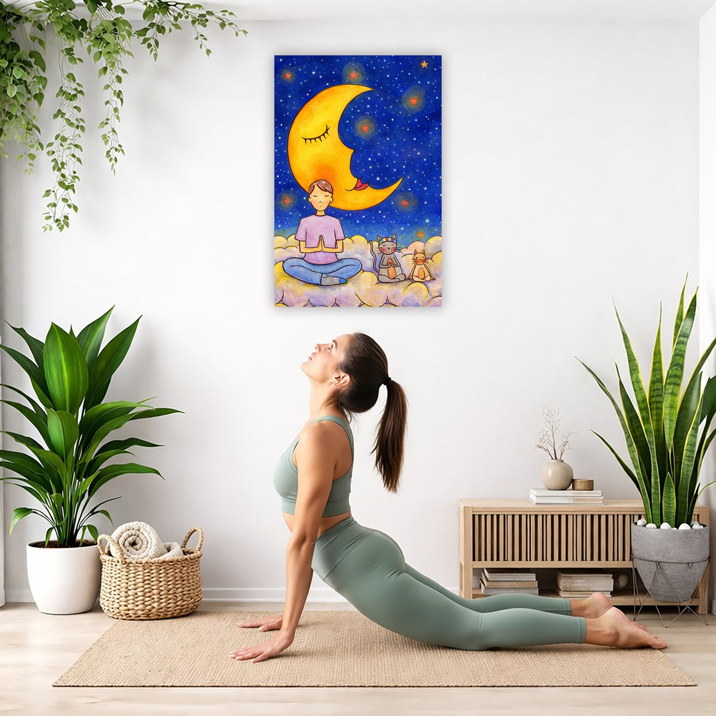 Man and his cats are meditating atop a cloud under the moon in a mindfulness poster.  The poster is hanging on the wall. A woman on her yoga mat is doing the cobra pose in front of the poster. There is a potted plant on the left side and a cabinet with a Buddha statue on it on the right side.
