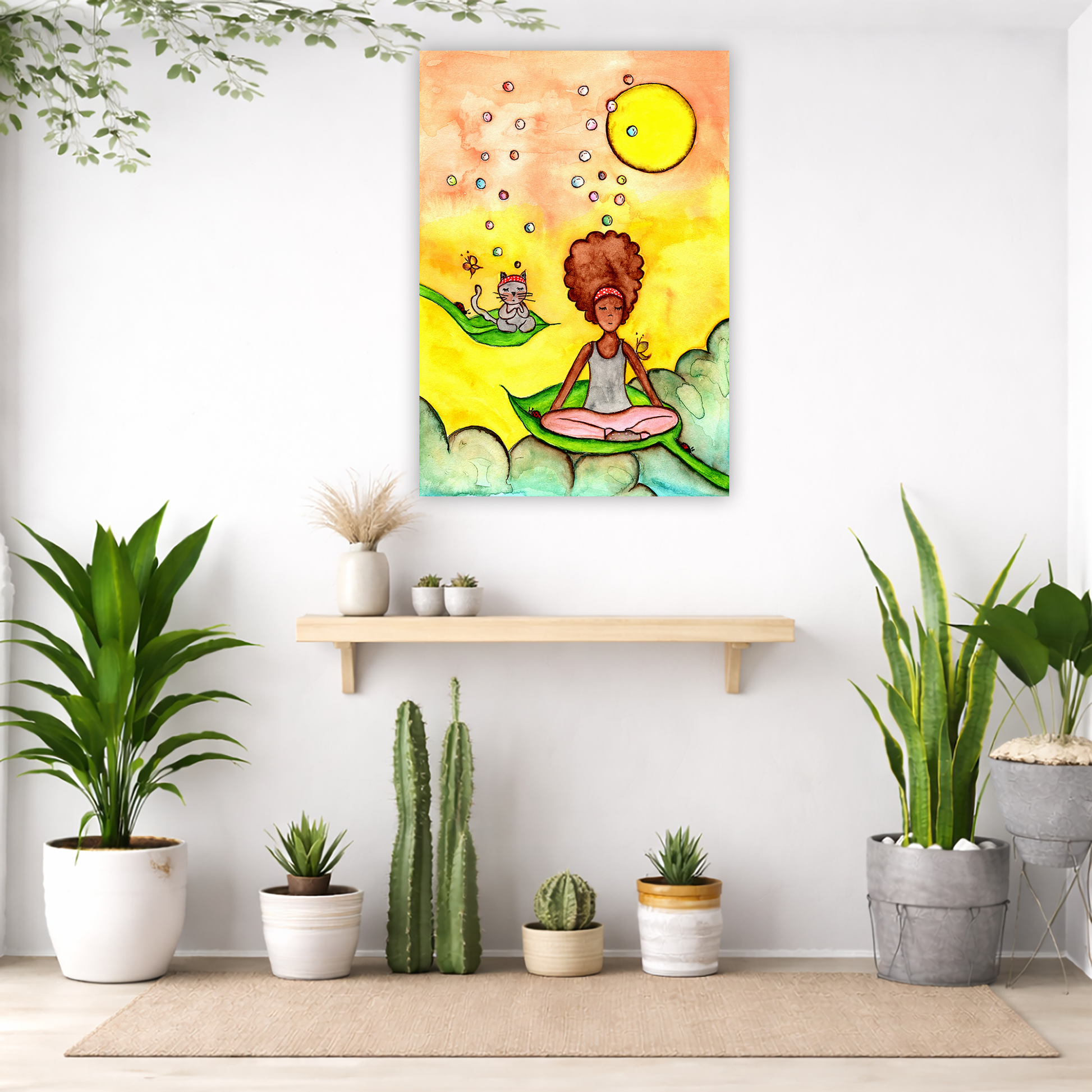 Canvas of a woman and her cat meditating while sitting on leaves. The background is bright yellow.  The canvas is in the center of the living room wall. Below the poster is an empty bench. Below the bench is a variety of green potted plants including a few cactus.
