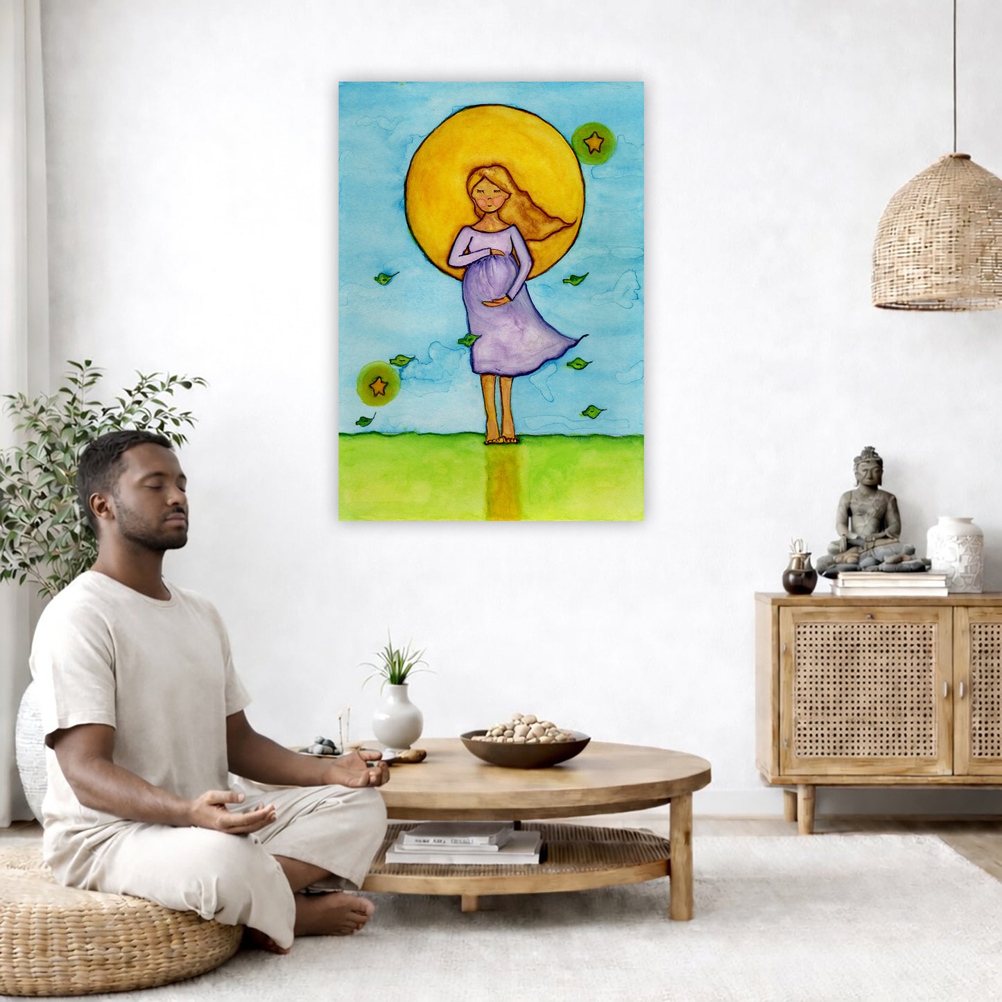 A woman standing in meditation under a bright yellow sun with a blue sky background, canvas watercolor print. The canvas is in the center of the living room wall. A man is on a chair on the left side of his living room meditating. On the right side is a cabinet with a Buddha statue on it.
