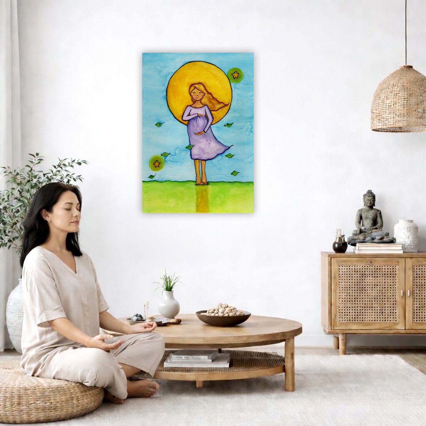 A woman standing in meditation under a bright yellow sun with a blue sky background, canvas watercolor print.  The canvas is in the center of the living room wall. A woman is on a chair on the left side of his living room meditating. There is a green potted plant behind her. On the right side is a cabinet with a Buddha statue on it.
