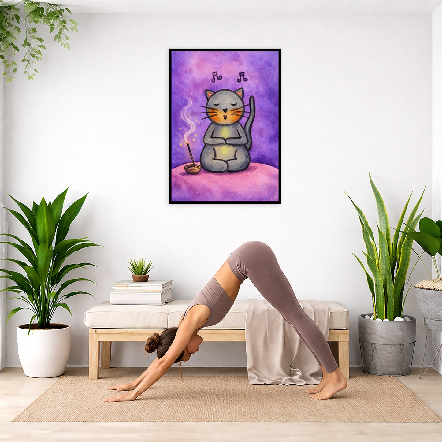 A gray cat chanting on a pink cloud framed poster. This is a print of the original hand-painted watercolor by Brazilian artist Thaís Suizo. The poster is in the center of the living room wall. Below the poster a woman is doing the yoga posture downward facing dog on a yoga mat.
