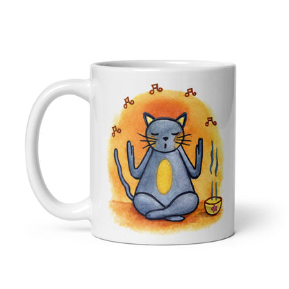 Gray cat chanting peacefully with music playing and incense smoke rising on an orange background in a calm setting coffee mug. This illustration of a cat meditating is on both sides of the mug. In this image the handle of the mug is on the right side.