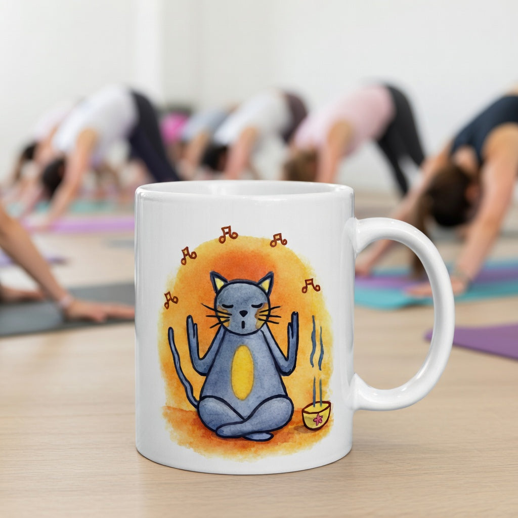 Gray cat chanting peacefully with music playing and incense smoke rising on an orange background in a calm setting coffee mug.  The mug is in front of a yoga class doing the downward facing dog posture.