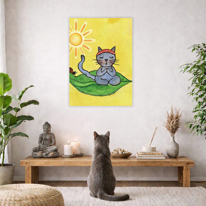 Gray cat meditating on a leaf in sunlight, peaceful nature-inspired mindfulness artwork. The poster is hanging on a living room wall. A gray cat is staring up at the poster. The coffee table below the poster has a Buddha statue and a lit candle. There is a white curtain to the left and a hanging lamp and a potted green plant on the right.
