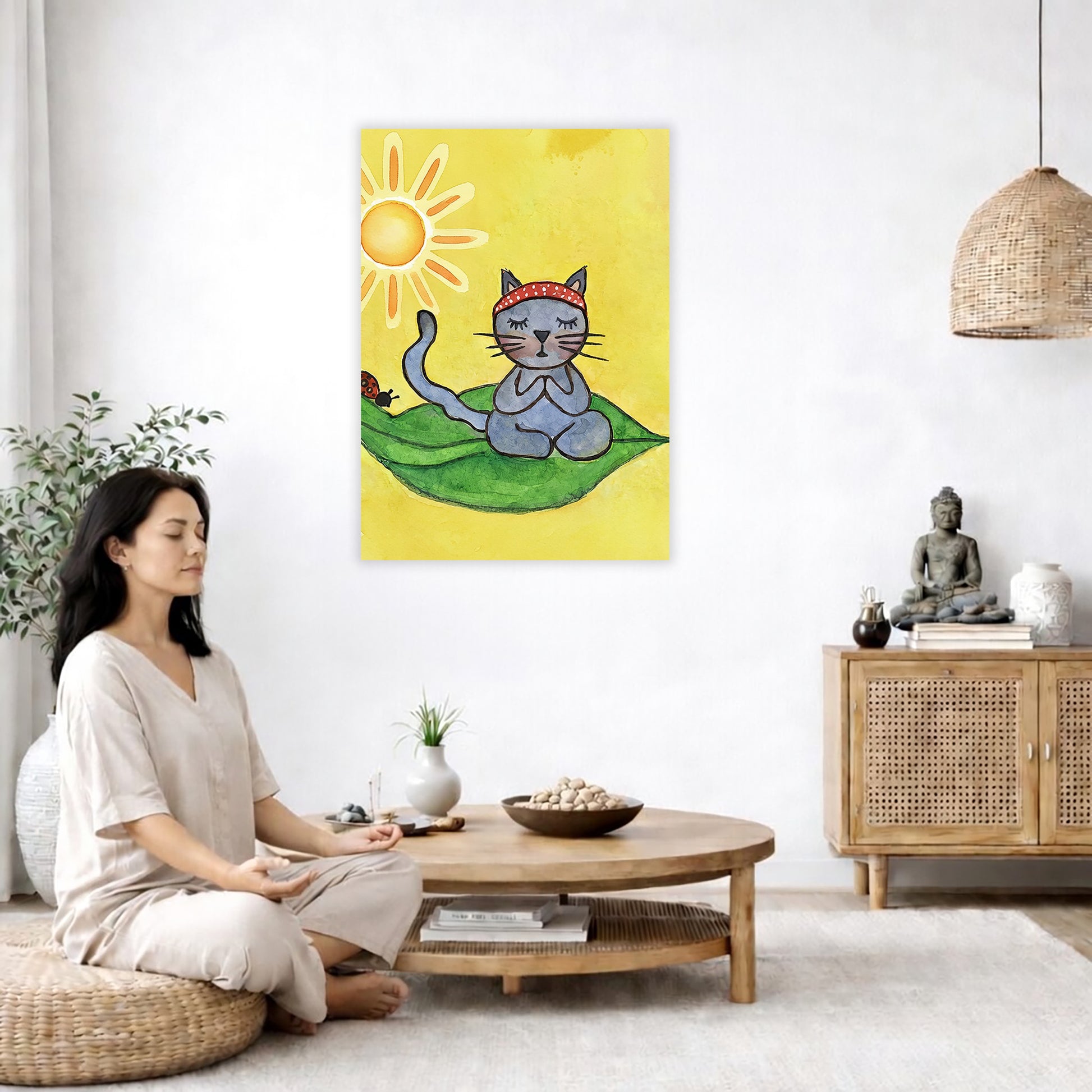 Gray cat meditating on a leaf in sunlight, peaceful nature-inspired mindfulness artwork. The poster is in the center of the living room wall. A woman is on a chair on the left side of his living room meditating. There is a green potted plant behind her. On the right side is a cabinet with a Buddha statue on it.
