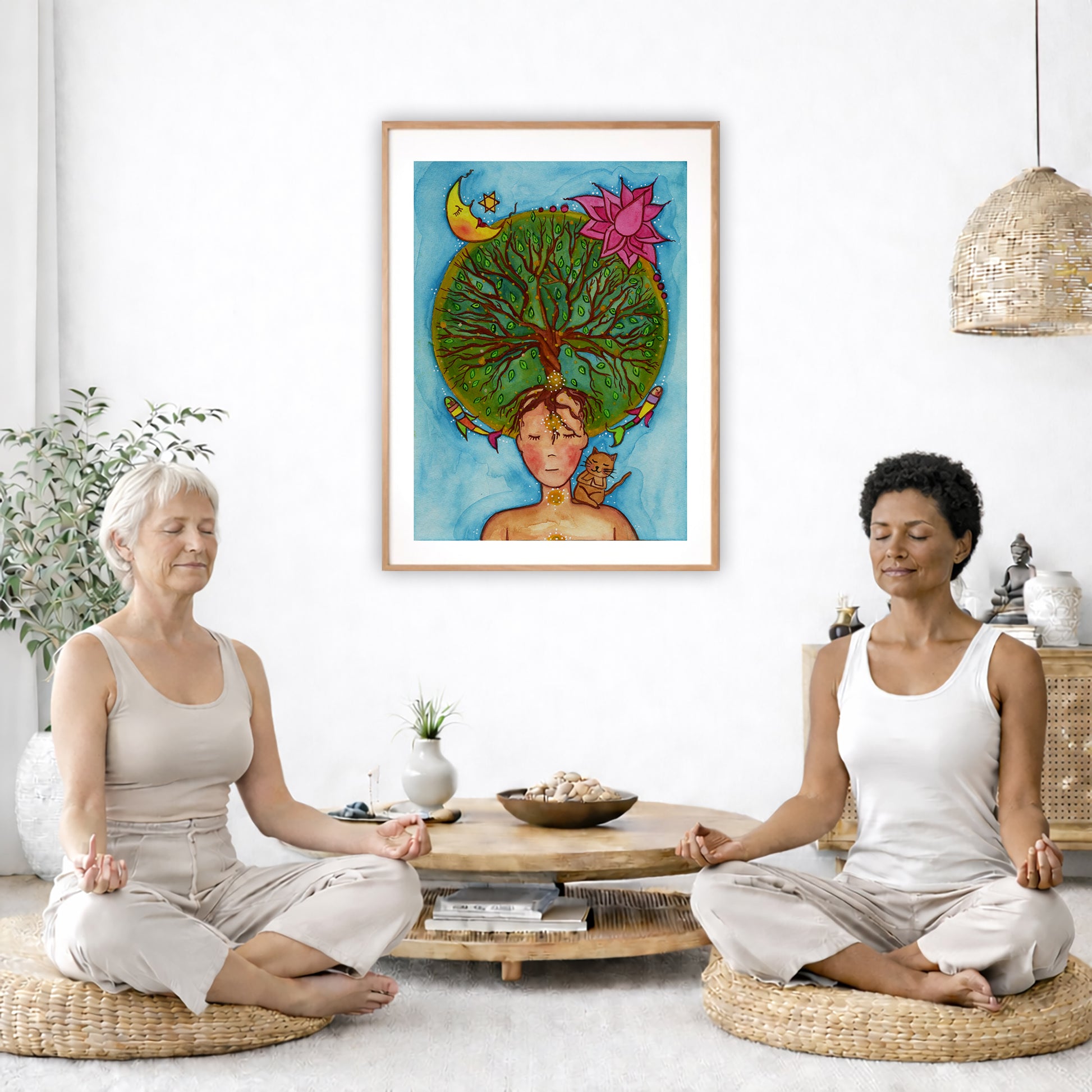 Poster of the crown chakra of a woman opening up like the tree of life. A cat is on her shoulder.  The poster is in the center of the living room wall. Two women are sitting on wicker pillows meditating. Behind them is a small round coffee table with incense, a green potted plant and a bowl of shells. There is a potted plant to the left and a Buddha statue and a vase to the right. 