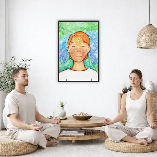 Framed poster of a man with a glowing brow chakra. The poster is in the center of the living room wall. Two friends are sitting on wicker pillows meditating. Between them is a small round coffee table with incense, a green potted plant and a bowl of shells. There is a potted plant to the left and a Buddha statue and a vase to the right. 