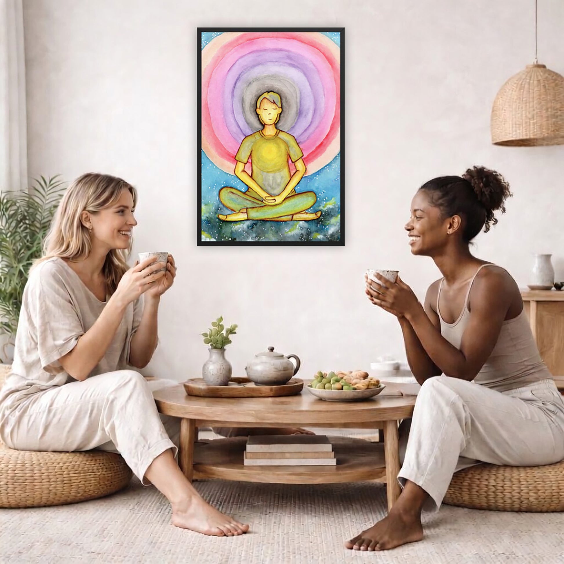 Framed poster of a man's heart chakra glowing and the colorful aura energy surrounding him.  The poster is in the center of the living room wall. Two female friends are having tea, grapes and cookies on a coffee table in front of the poster. On the left there is a green potted plant and to the right there is a hanging lamp.
