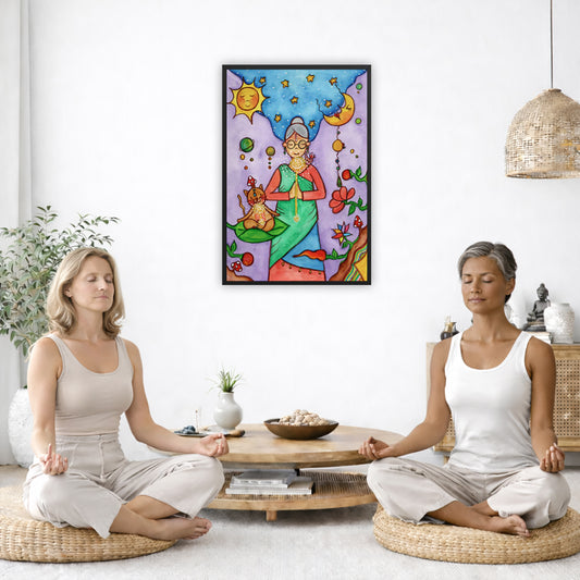 Framed poster of woman in standing prayer meditation with glowing throat chakra under sun and moon. Her cat is meditating beside her.  The poster is in the center of the living room wall. Two women are sitting on a giant pillow having a coffee. Beside them is a small tray with a pot of coffee and incense. To the left is a green floor plant and a hanging green plant. To the right of them is a green floor plant.