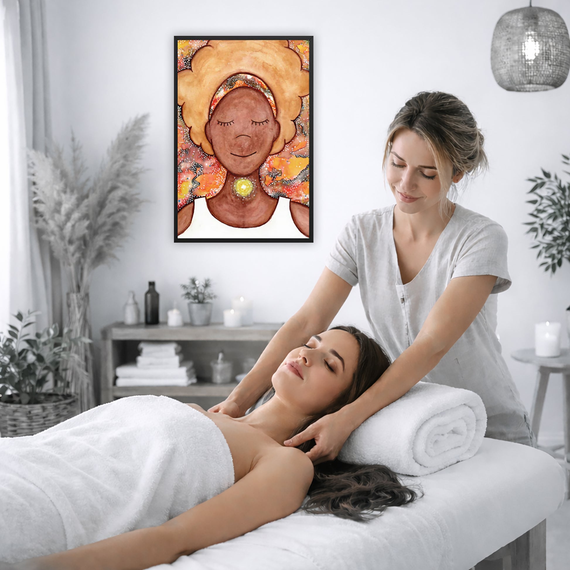 Framed poster of a woman mediating with a glowing throat chakra. The poster is on the wall of the office of a massage therapist. The therapist is giving her female client a massage. The client is lying face up on a massage table wearing a white towel. To the left is a window, floor plant and large vase of dry flora. A shelf is underneath the poster with candles burning. There is a candle burning on a small table and a hanging lamp with a wicker shade on the right side.