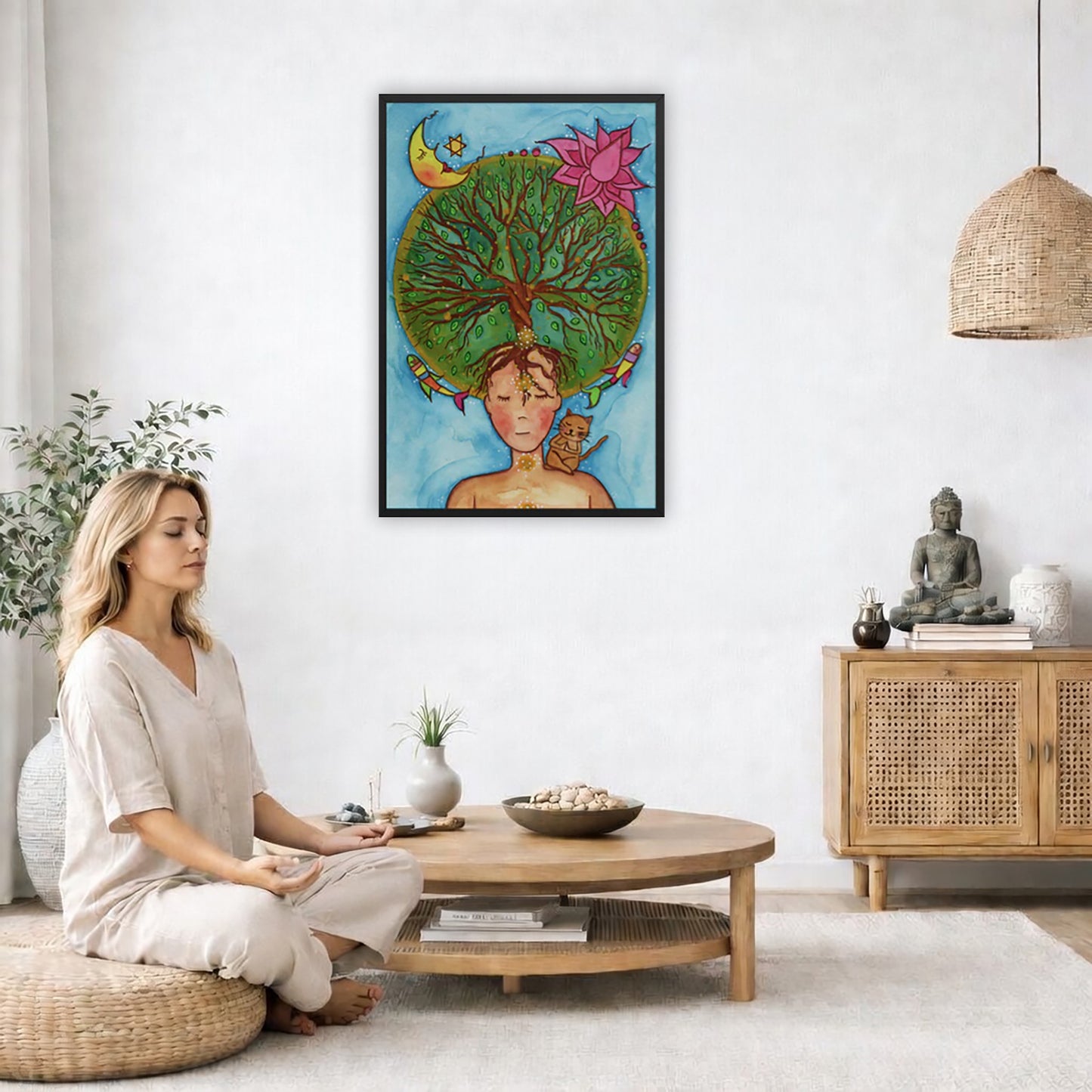 Framed poster of the crown chakra of a woman opening up like the tree of life. A cat is on her shoulder.  The poster is in the center of the living room wall. A woman is on a chair on the left side of his living room meditating. There is a green potted plant behind her. On the right side is a cabinet with a Buddha statue on it.

