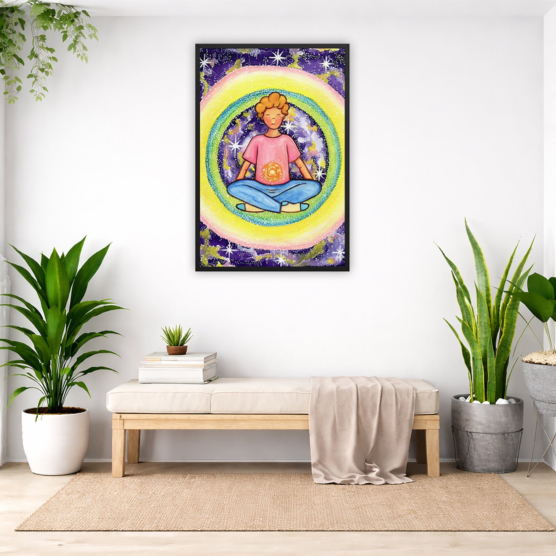 Framed poster of a young man meditating with his solar plexus glowing. He is basking in his colorful aura.  The poster is in the center of the living room wall. Below the poster is a padded bench. On the bench is a pile of books and a small green potted plant. There is a silk sheet draped over the bench. There is a green hanging plant and floor plant on the left. There are two floor plants on the right.
