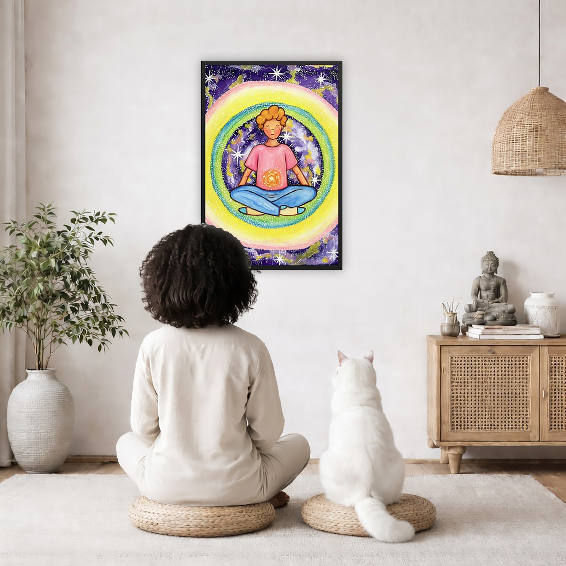 Framed poster of a young man meditating with his solar plexus glowing. He is basking in his colorful aura.  The poster is in the center of the living room wall. A woman and a cat are staring up at the poster. There is a potted plant on the left side and a cabinet with a Buddha statue, books and incense on the right side.
 
