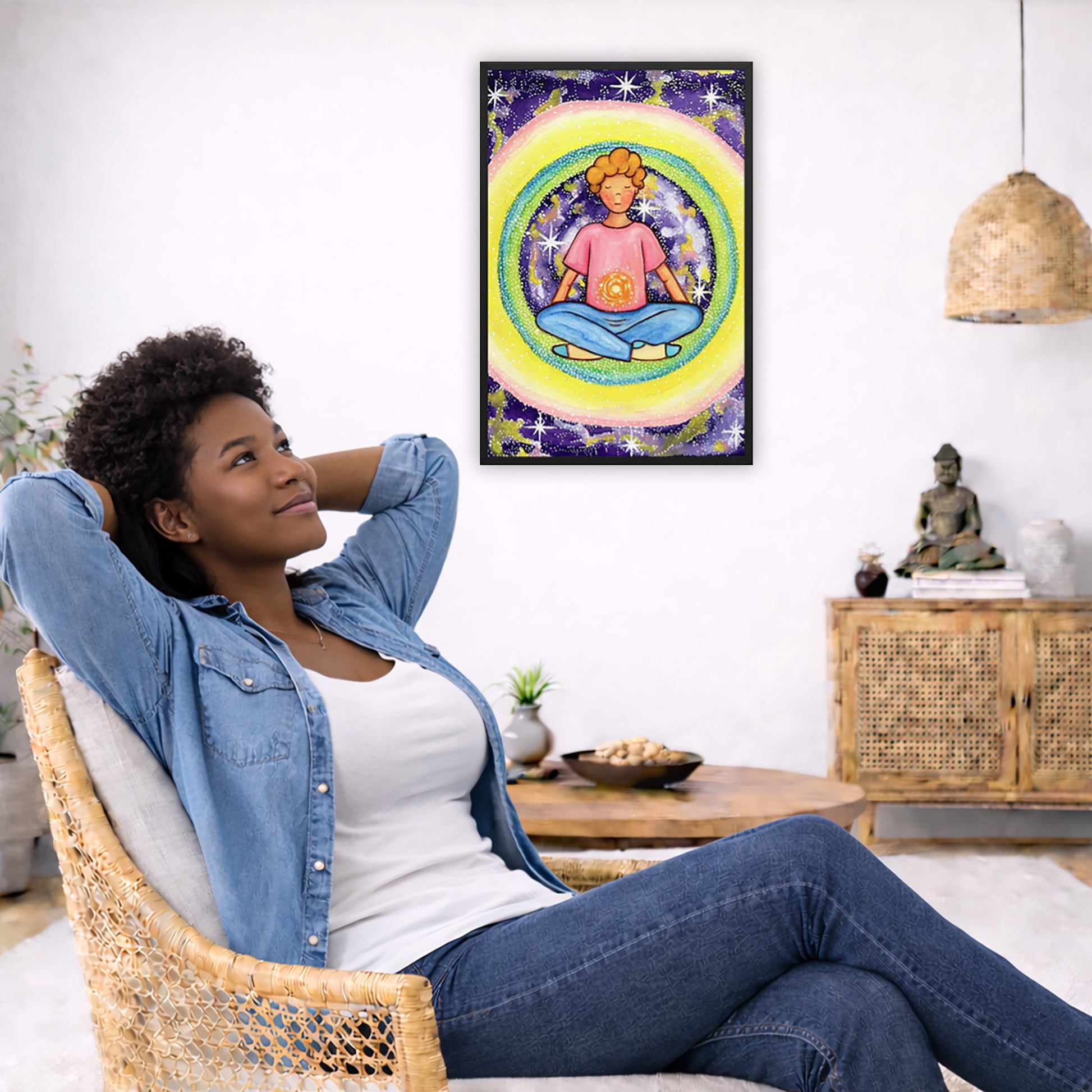 Framed poster of a young man meditating with his solar plexus glowing. He is basking in his colorful aura.  The poster is in the center of the living room wall. To the left a woman is relaxing in her chair with her hands behind her head. There is a small coffee table beside her with a bowl of walnuts, incense and a small green plant. On the right side of the room is a cabinet with a Buddha statue, books and an urn on it. To the left is a green floor plant.
