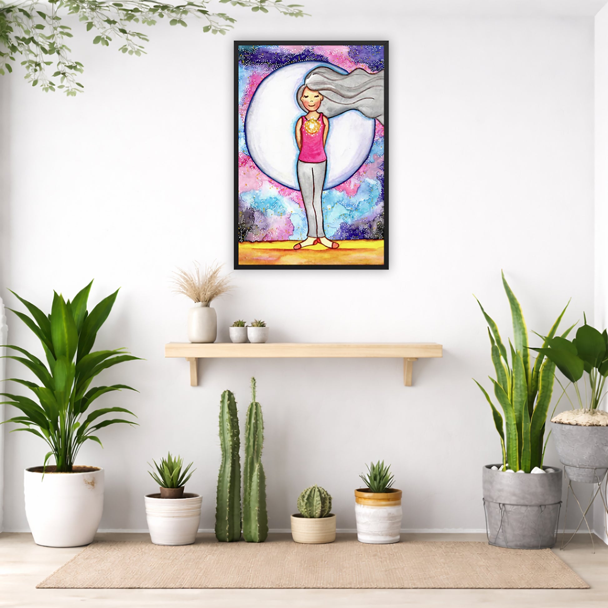 Framed poster of a woman's heart chakra glowing with beautiful love energy.  The poster is in the center of the living room wall. Below the poster is a bench. On the bench is burning incense and a couple of bowls. There is a green potted plant on both the left and right side of the bench. There is a hanging plant on the left.
