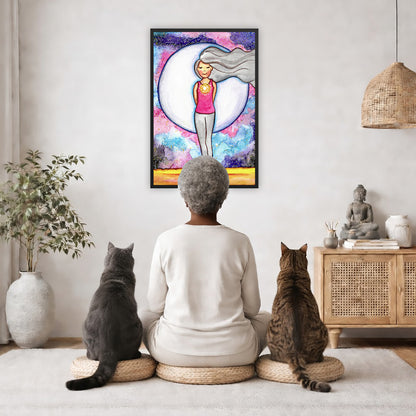 Framed poster of a woman's heart chakra glowing with beautiful love energy. The poster is in the center of the living room wall. A woman is meditating facing the poster with a white cat on her left side and a black cat on her right side. There is a potted plant on the left side and a cabinet with a Buddha statue on it on the right side. 
