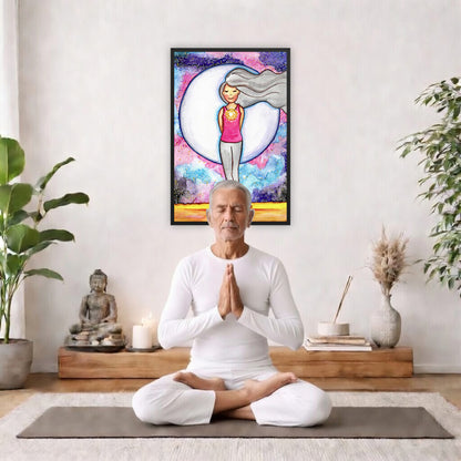 Framed poster of a woman's heart chakra glowing with beautiful love energy.   The poster is framed hanging on a living room wall. A man is mediating facing the poster. There is a coffee table in front of him with burning candles and a Buddha statue. There are green potted plants on each side of the room.
