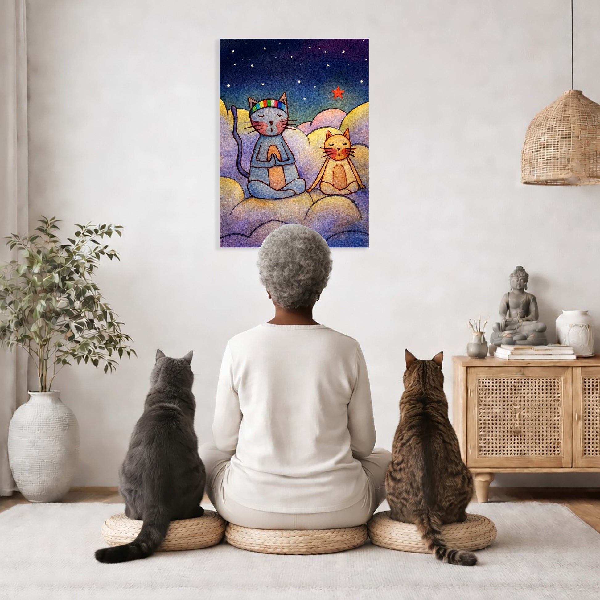 Two cats are meditating on a cloud at night. This is a print of the original hand-painted watercolor by Brazilian artist Thaís Suizo for the LET'S MEDITATE SERIES of mediation guides.  The poster is in the center of the living room wall. A woman is meditating facing the poster with a white cat on her left side and a black cat on her right side. There is a potted plant on the left side and a cabinet with a Buddha statue on it on the right side. 
