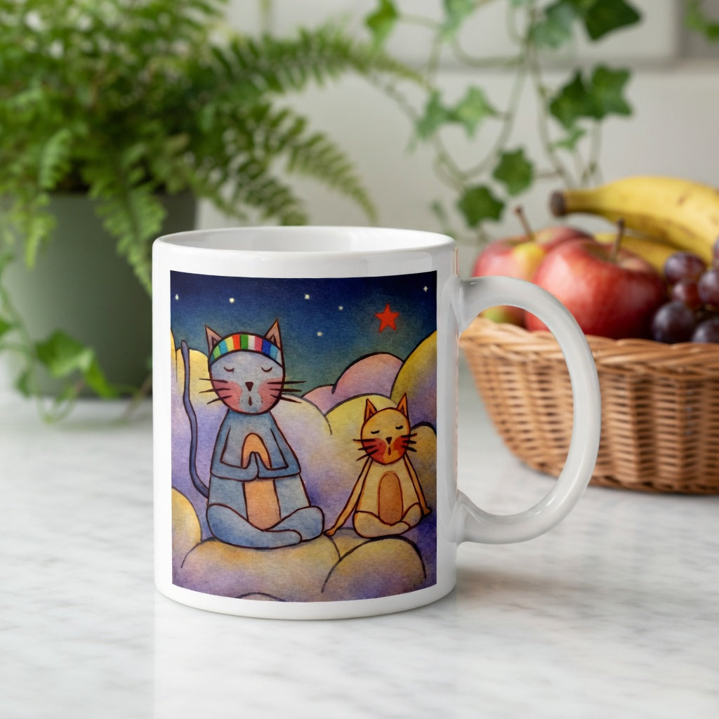 Two cats meditating on a cloud under the night sky mindfulness mug.  Behind the mug is a basket of fruit and a green potted plant.