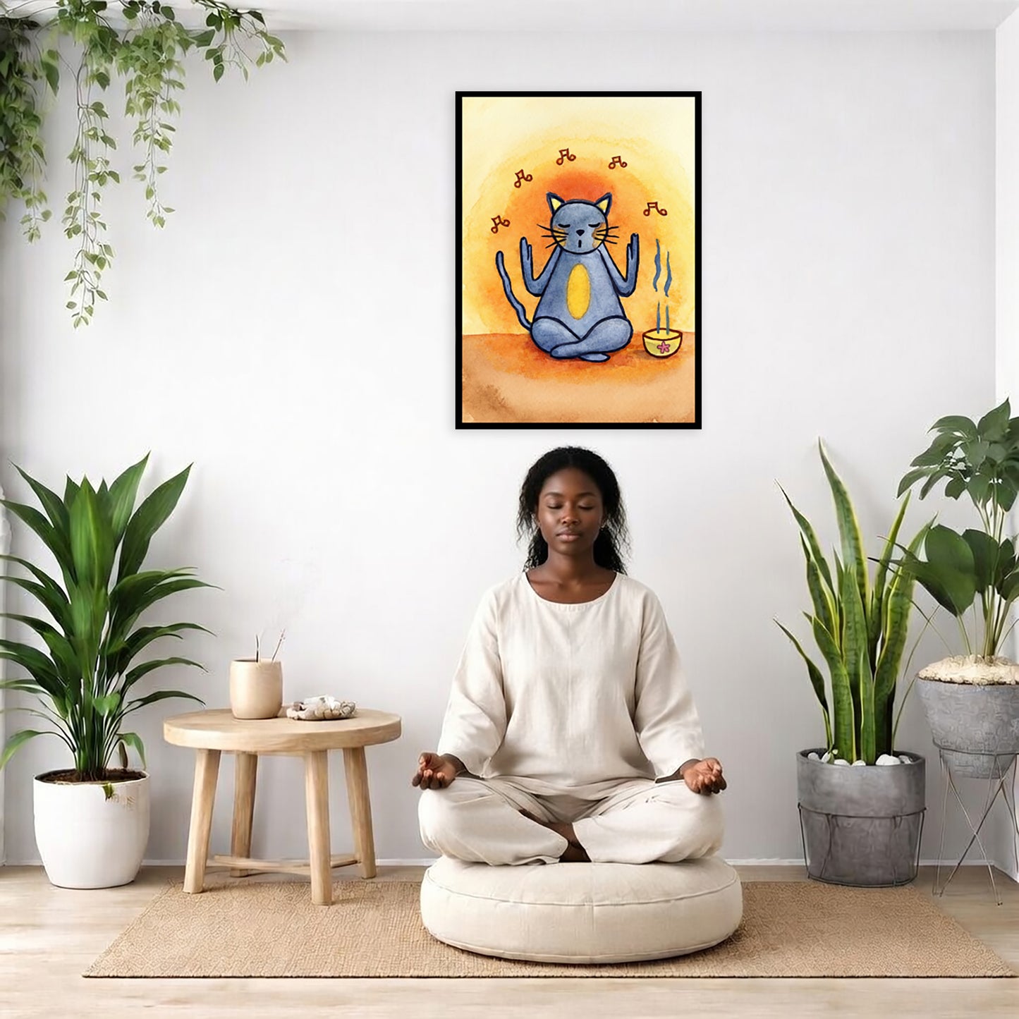 Gray cat chants with incense burning framed poster.  This is a print of the original hand-painted watercolor by Brazilian artist Thaís Suizo. There is a woman meditating on a pillow facing away from the wall. There is a small table beside her with incense and meditation stones. There are potted plants on the right and left side of the background.
