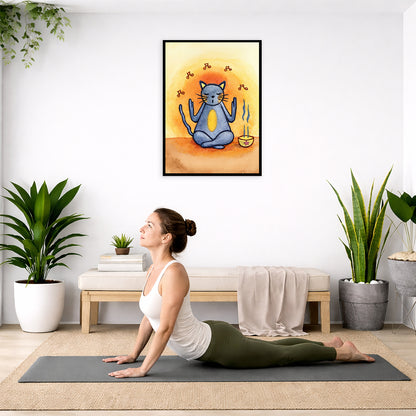 Gray cat chants with incense burning framed poster.  This is a print of the original hand-painted watercolor by Brazilian artist Thaís Suizo. The poster is hanging on the wall. A woman on her yoga mat is doing the cobra pose in front of the poster. There is a potted plant on the left side and a cabinet with a Buddha statue on it on the right side.
