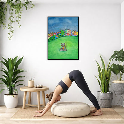 A gray cat meditating in the park framed poster. This is a print of the original hand-painted watercolor by Brazilian artist Thaís Suizo. The poster is in the center of the living room wall. Below the poster a woman is doing the yoga posture downward facing dog on a yoga mat.
