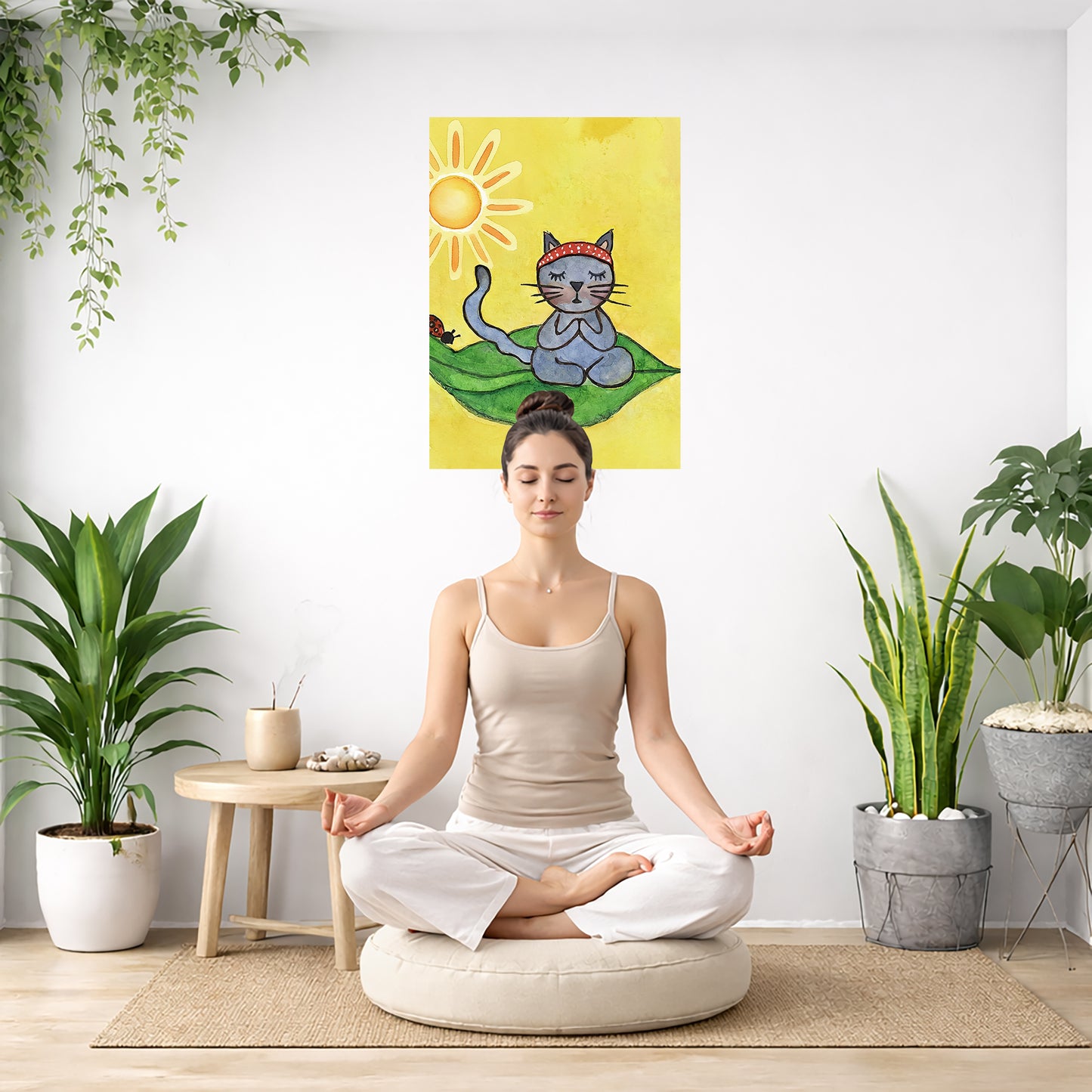 Woman meditating on a cushion in a room with plants and a colorful wall art of a cat.
