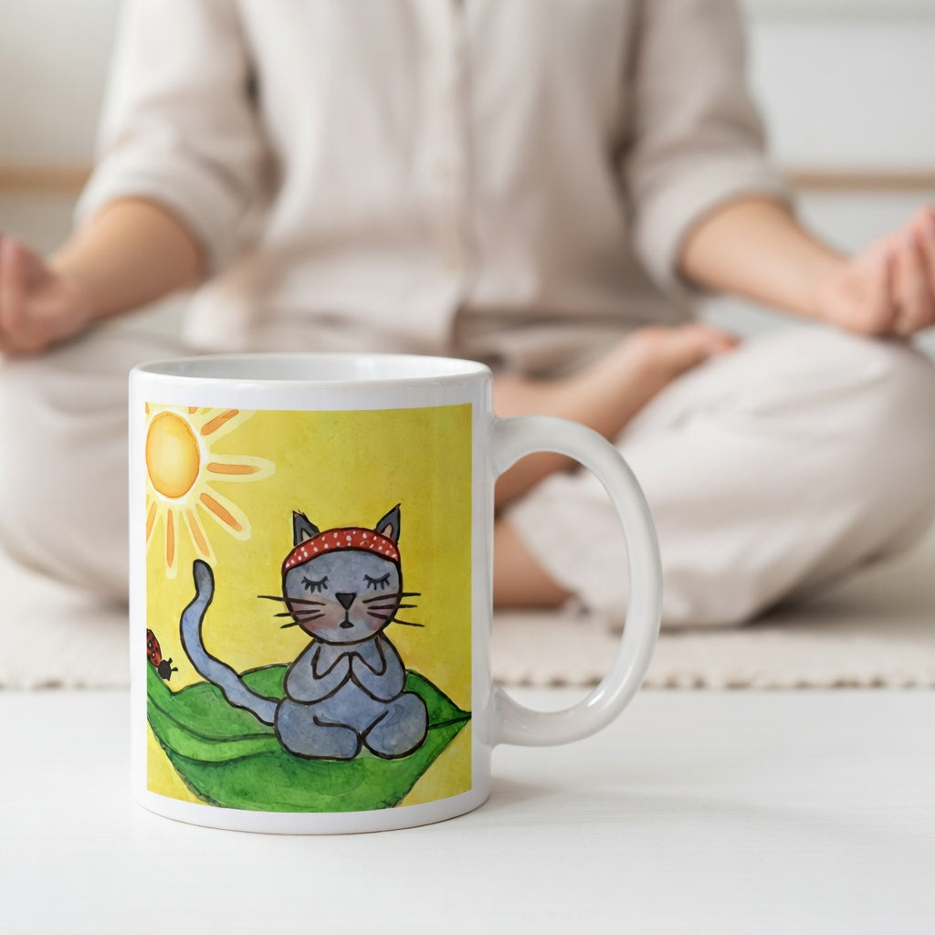 Gray cat meditating peacefully on a leaf in the bright sunlight meditation mug. A woman is meditating in the background.