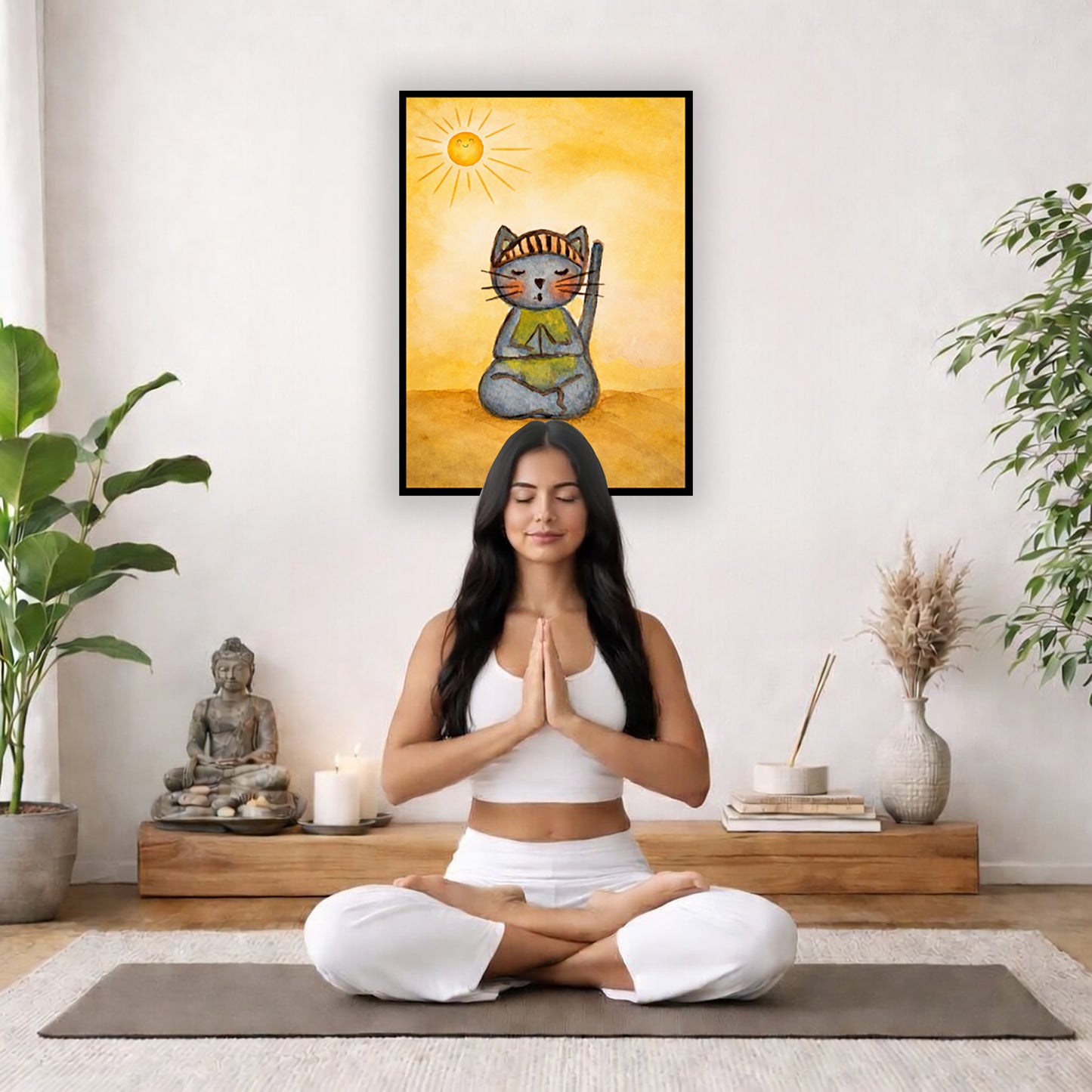 A gray cat meditating on a sunny day framed poster.  This is a print of the original hand-painted watercolor by Brazilian artist Thaís Suizo. The poster is in the center of the living room wall. There is a woman meditating facing away from the wall. Behind her is a coffee table with incense and a Buddha statue. There are potted plants on the right and left side of the background.
