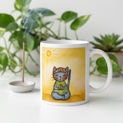 Gray cat meditating on a sunny day mindfulness mug.  Incense is burning beside the mug. There are green potted plants in the background.