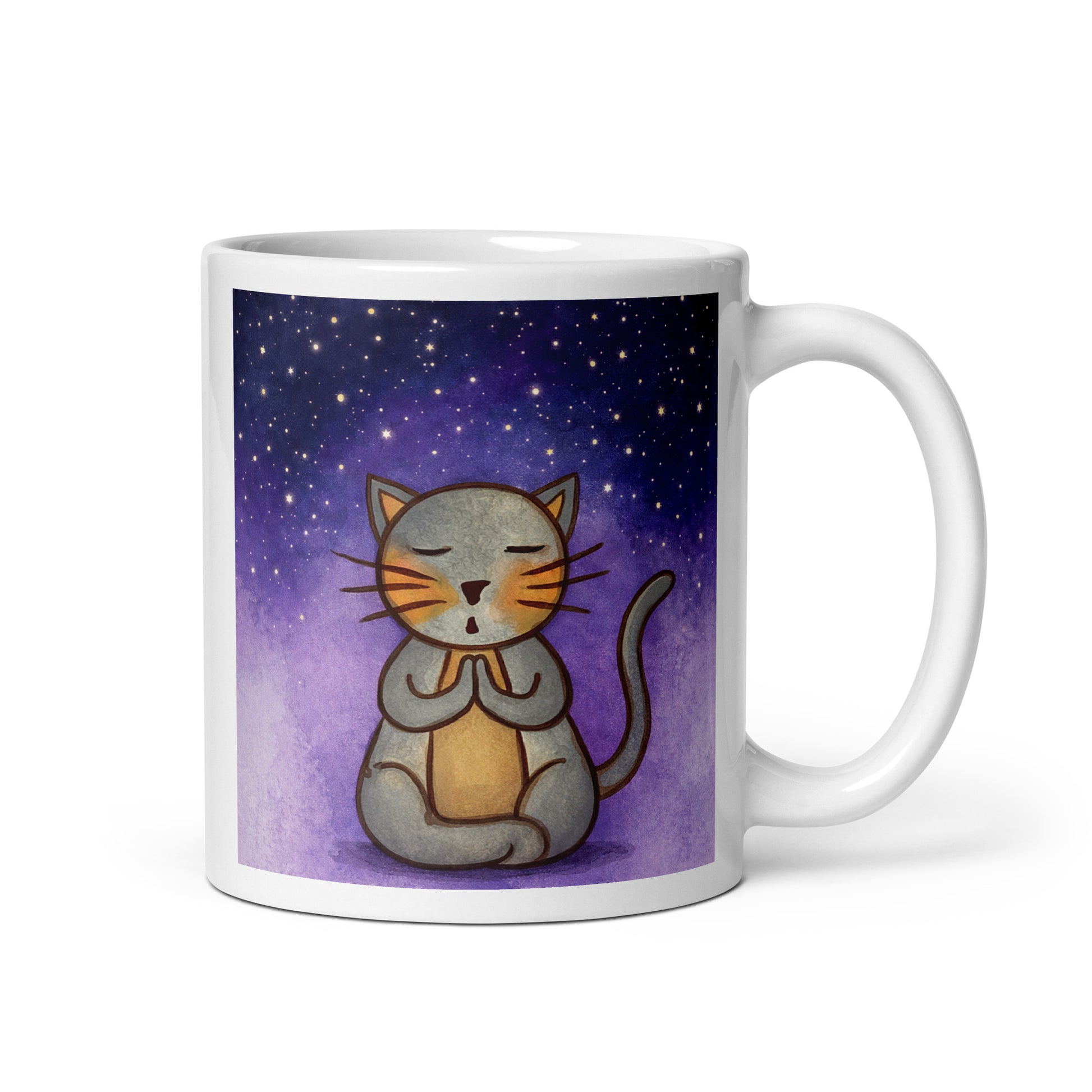 Gray cat meditating under a starry night sky with a peaceful mindfulness coffee mug. This illustration of a cat meditating is on both sides of the mug. In this image the handle of the mug is on the right side.