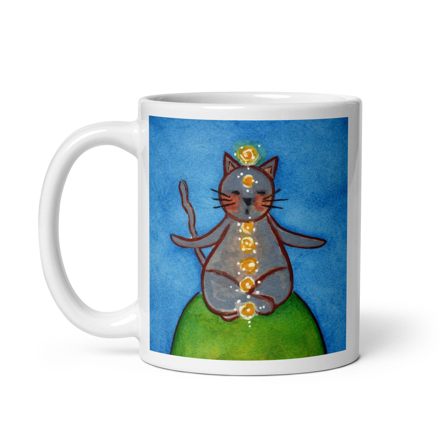 Gray cat meditating with glowing chakras on a deep blue calming background. This illustration of a cat meditating is on both sides of the mug. In this image the handle of the mug is on the left side.