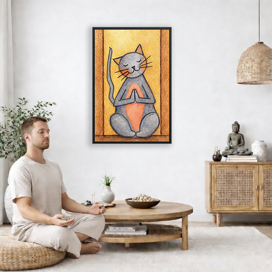 A gray cat with a pink belly is doing a standing meditation framed poster.  This is a print of the original hand-painted watercolor by Brazilian artist Thaís Suizo.  The poster is in the center of the living room wall. A man is on a chair on the left side of his living room meditating. On the right side is a cabinet with a Buddha statue on it.
