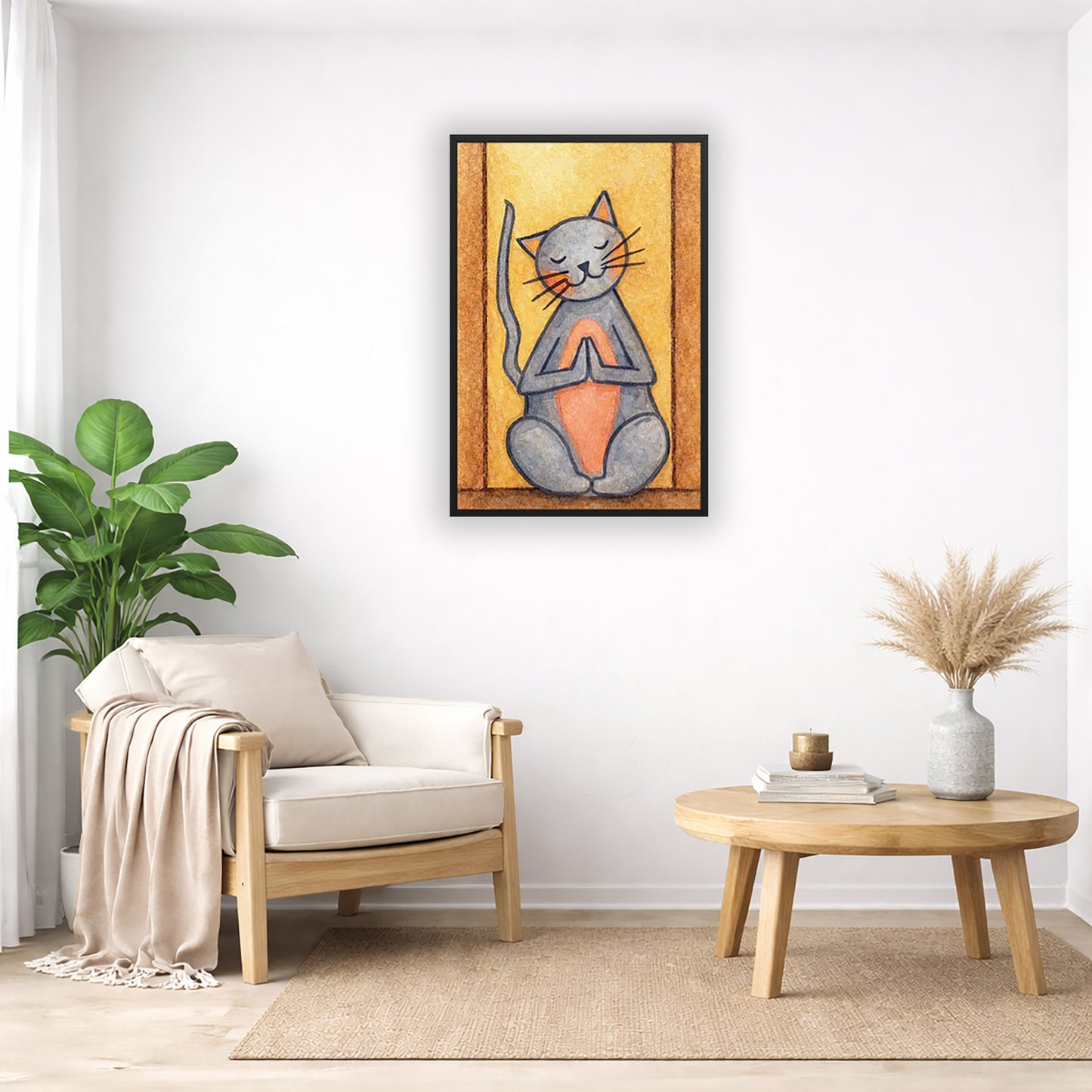 A gray cat with a pink belly is doing a standing meditation framed poster.  This is a print of the original hand-painted watercolor by Brazilian artist Thaís Suizo.  The poster is in the center of the living room wall. Below the poster to the left is a living room chair, a floor plant and white curtains. To the right is a small table with books, a candle and a vase with dry flora.
