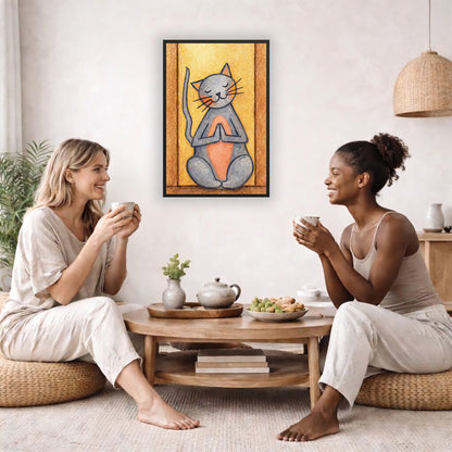 A gray cat with a pink belly is doing a standing meditation framed poster.  This is a print of the original hand-painted watercolor by Brazilian artist Thaís Suizo.  The poster is in the center of the living room wall. Two female friends are having tea, grapes and cookies on a coffee table in front of the poster. On the left there is a green potted plant and to the right there is a hanging lamp.
