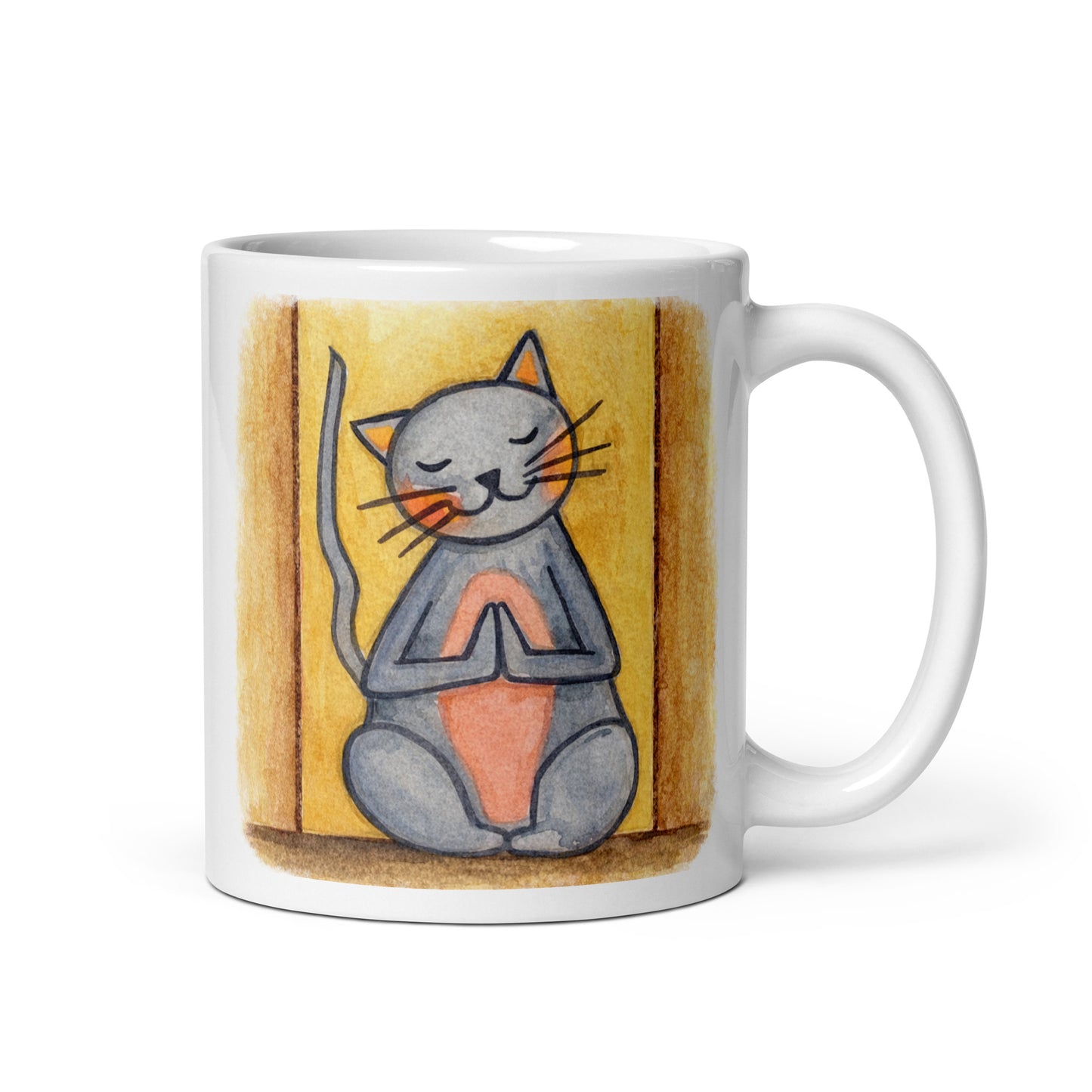 Gray cat with a pink belly on a yellow background is sitting in a peaceful meditation pose with praying paws in front of its chest. This illustration of a cat meditating is on both sides of the mug. In this image the handle of the mug is on the right side.