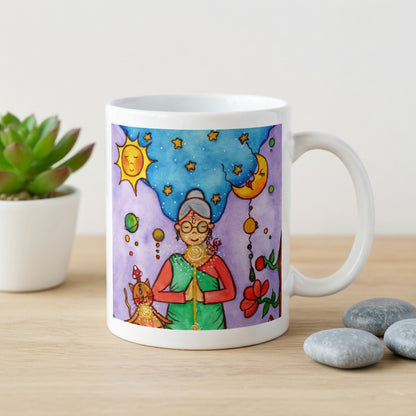 Woman and her cat meditating under sun and moon, peaceful scene representing harmony, balance and connection, spiritual coffee mug design.  The mug is on a counter. Beside the mug are meditation stones. Behind the mug is a green potted plant.