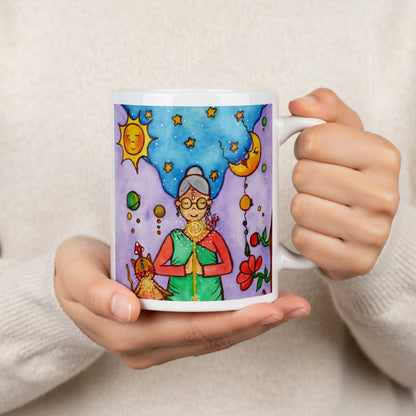 Woman and her cat meditating under sun and moon, peaceful scene representing harmony, balance and connection, spiritual coffee mug design.  The hands of a person wearing a white sweater are holding the mug up to display the design.